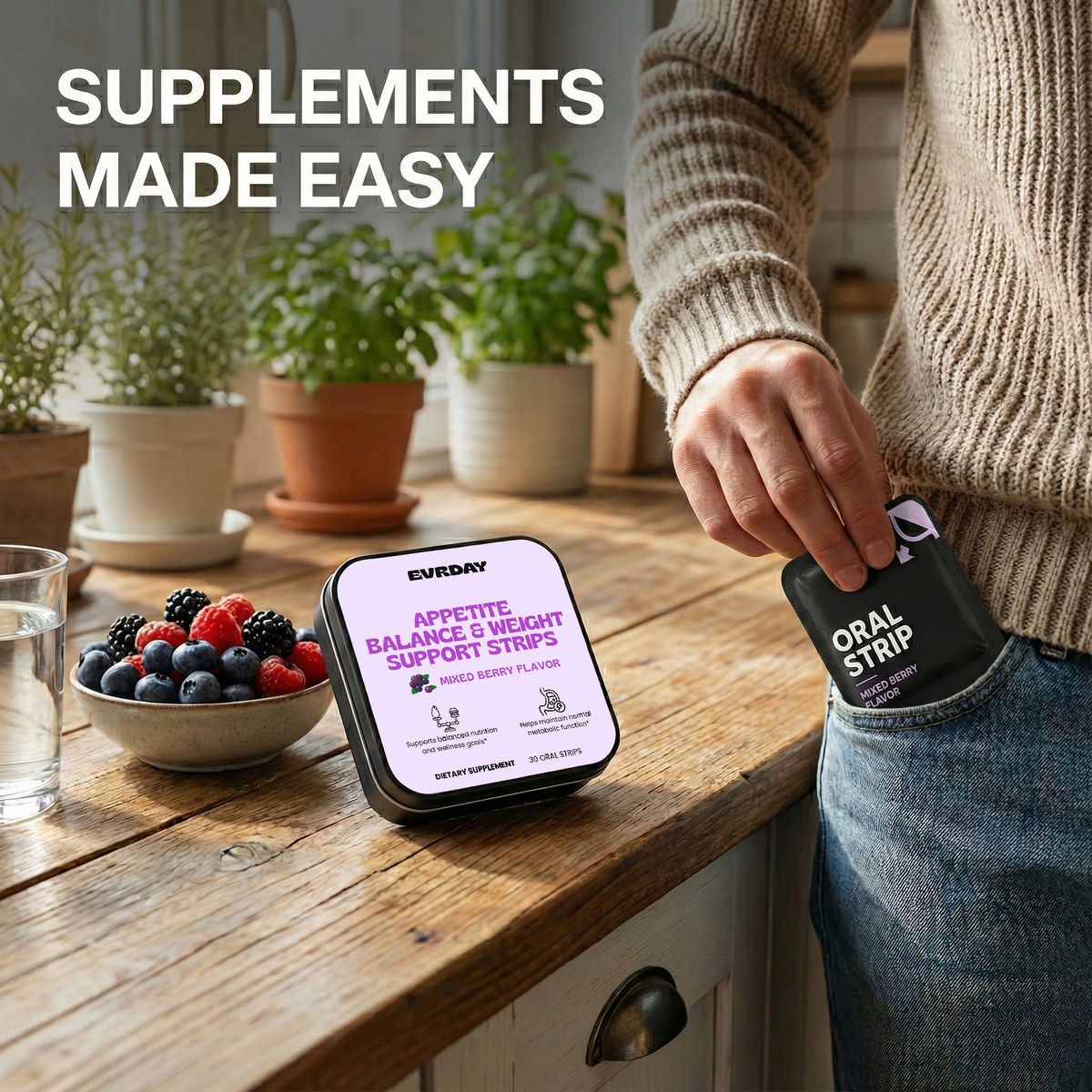Person holding a supplement container with a display of berries and a glass on a wooden table.